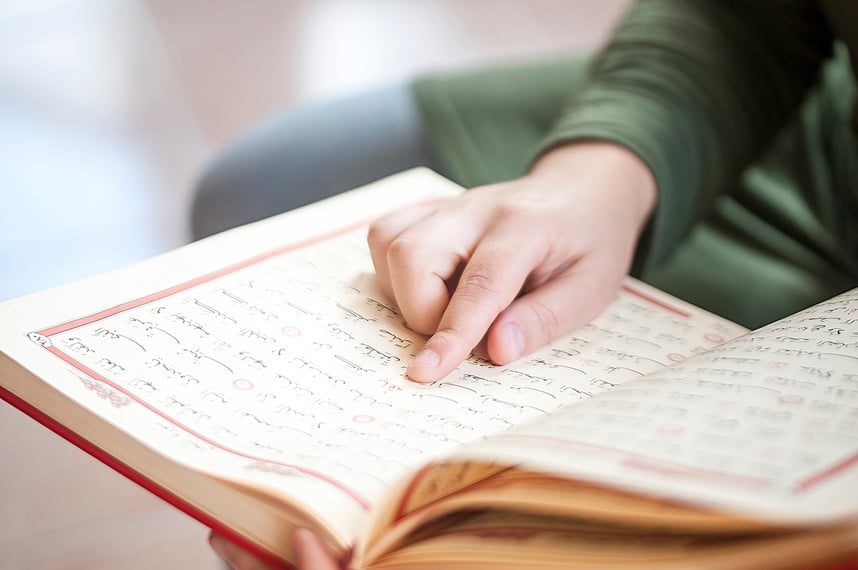 Young woman reading the Holy Qur'an