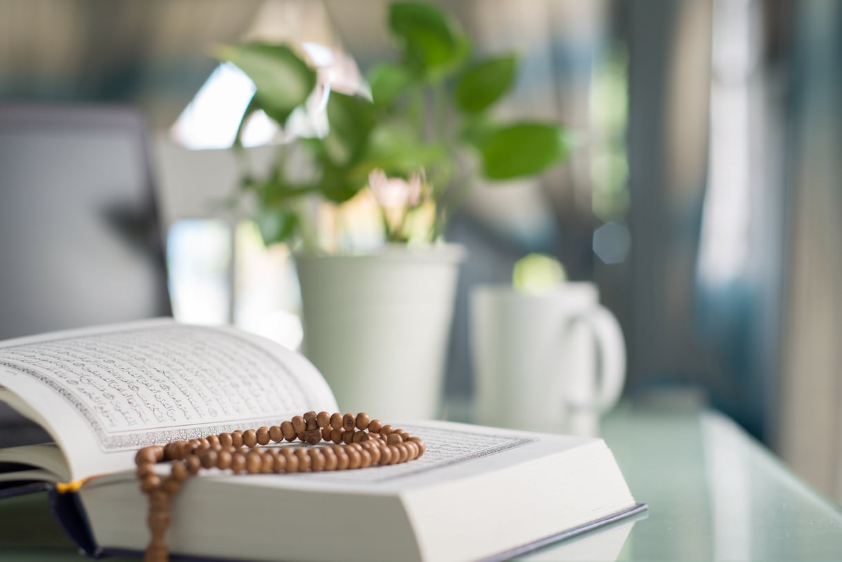 Al-Quran and beads with natural light at home